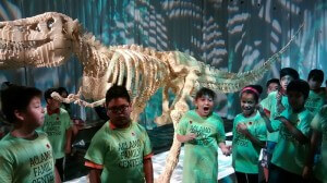 Students react to lego dinosaur.