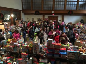 From 9 to noon, families moved through the hall under the helpful eye of a volunteer escort, who helped each child pick out three toys.