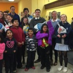 Students and faculty members from Episcopal Academy pause during distribution for a picture with some recipient families.