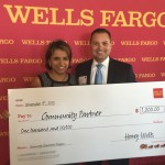 Accepting a donation check from Wells Fargo's Anthony Rosado. 